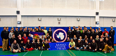 2007 Study Updates/Photos - Study volunteers holding the Mayo flag in the South Pole station gym.
