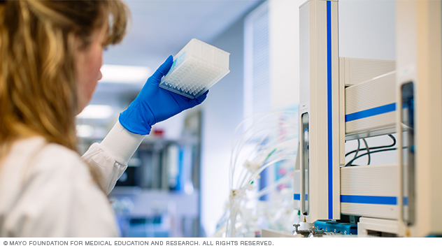 Targeted Biomarker Core staff member viewing specimens at Mayo Clinic in Minnesota.