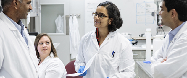 Investigators in Mayo Clinic's Human Immunodeficiency Virus Lab discussing research findings.
