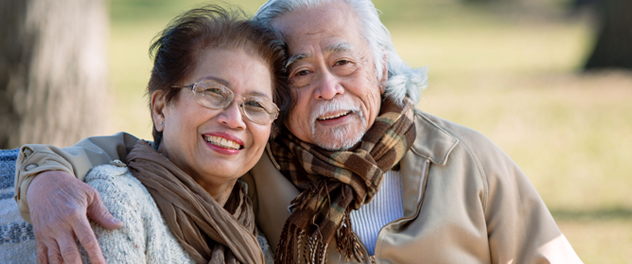 Smiling older couple with arms around each other