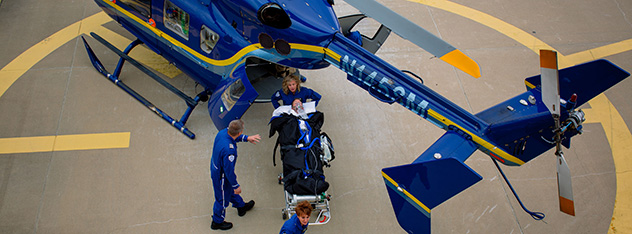 Paramedics unload a patient from Mayo One helicopter ambulance