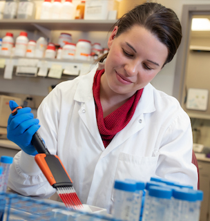 GI lab staff member pipetting.