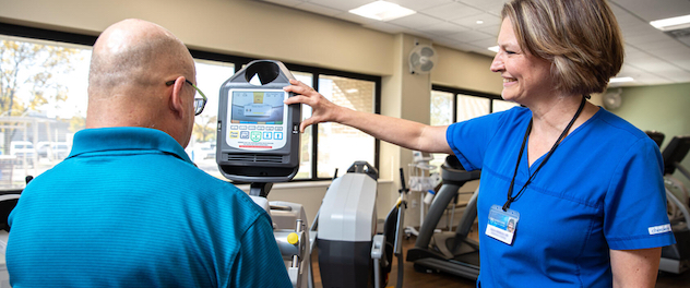 Person using a recumbent ergometer exercise bike