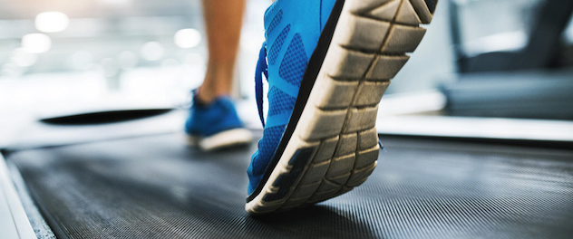 Focus on feet of person walking on a treadmill