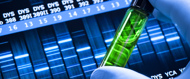 Lab sample tube in a technician's hand in front of DNA sequences