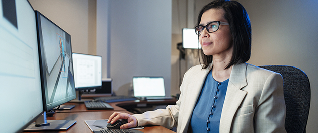 Farwa Ali, M.B.B.S., sits at a workstation in her lab.