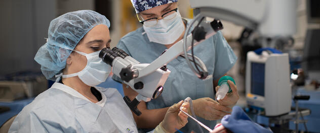 Otolaryngology trainee and mentor using an operative microscope