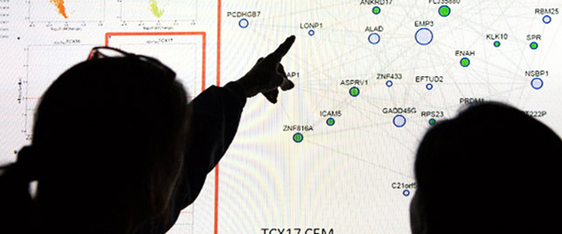 Researchers in the Precision Medicine in Neurodegeneration Lab examine gene encodings.
