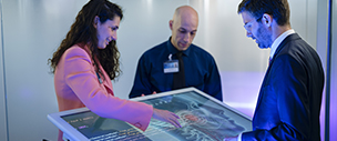 Artificial intelligence researchers working together with touch screen tablet.