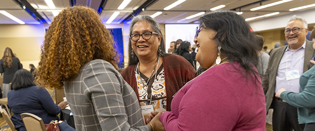 Community Partnership Summit participants greet one another.